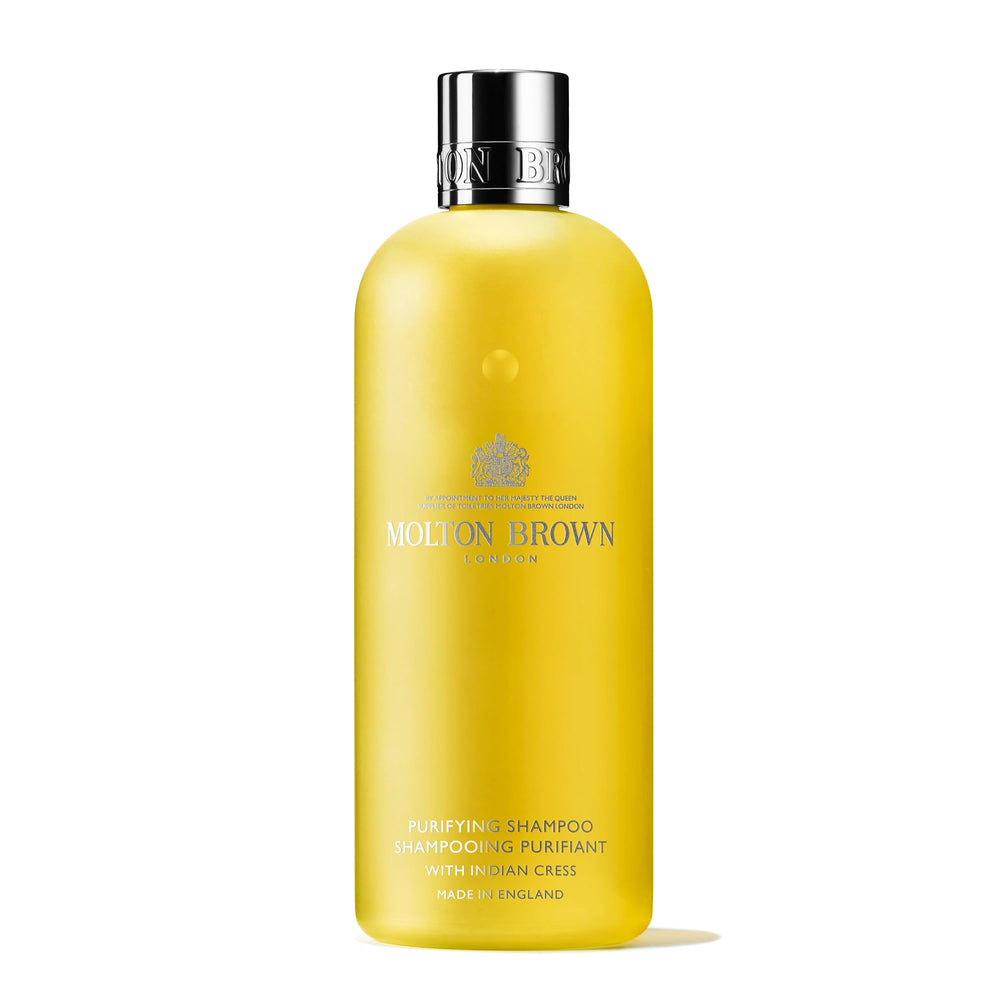 Molton Brown Purifying Shampoo bottle on a bathroom shelf for a refreshing cleanse
