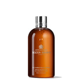Molton Brown Re-Charge Black Pepper bottle on a bathroom shelf energising morning routine