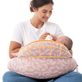 Momcozy Original Nursing Pillow with Safety Guard cradling baby for secure feeding.