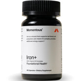 Momentous Iron+ bottle on table supports steady energy during workouts