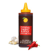 Momofuku Sweet & Spicy Korean BBQ Sauce bottle on a kitchen counter, bold and glossy.