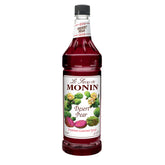 Monin Desert Pear Syrup bottle elevates drinks with a bold fuchsia hue.