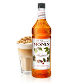 Monin Hazelnut Syrup bottle on counter with rich aroma for beverages