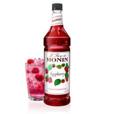 Monin Raspberry Syrup bottle pouring, ideal for cocktails and lemonades