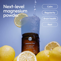Moon Juice Magnesi-Om powder scoop ready to mix for calm evenings.