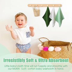 MUKIN baby-face wipe use shown for gentle newborn facial cleansing.