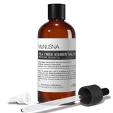 MUNUSNA Tea Tree Oil bottle close-up for skin and hair care.