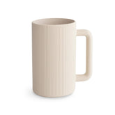 Mushie bath rinse cup with shifting sand pour for controlled water flow during bathtime.