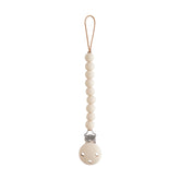 Mushie Hera pacifier clip packaging for easy gifting and travel-ready organization.