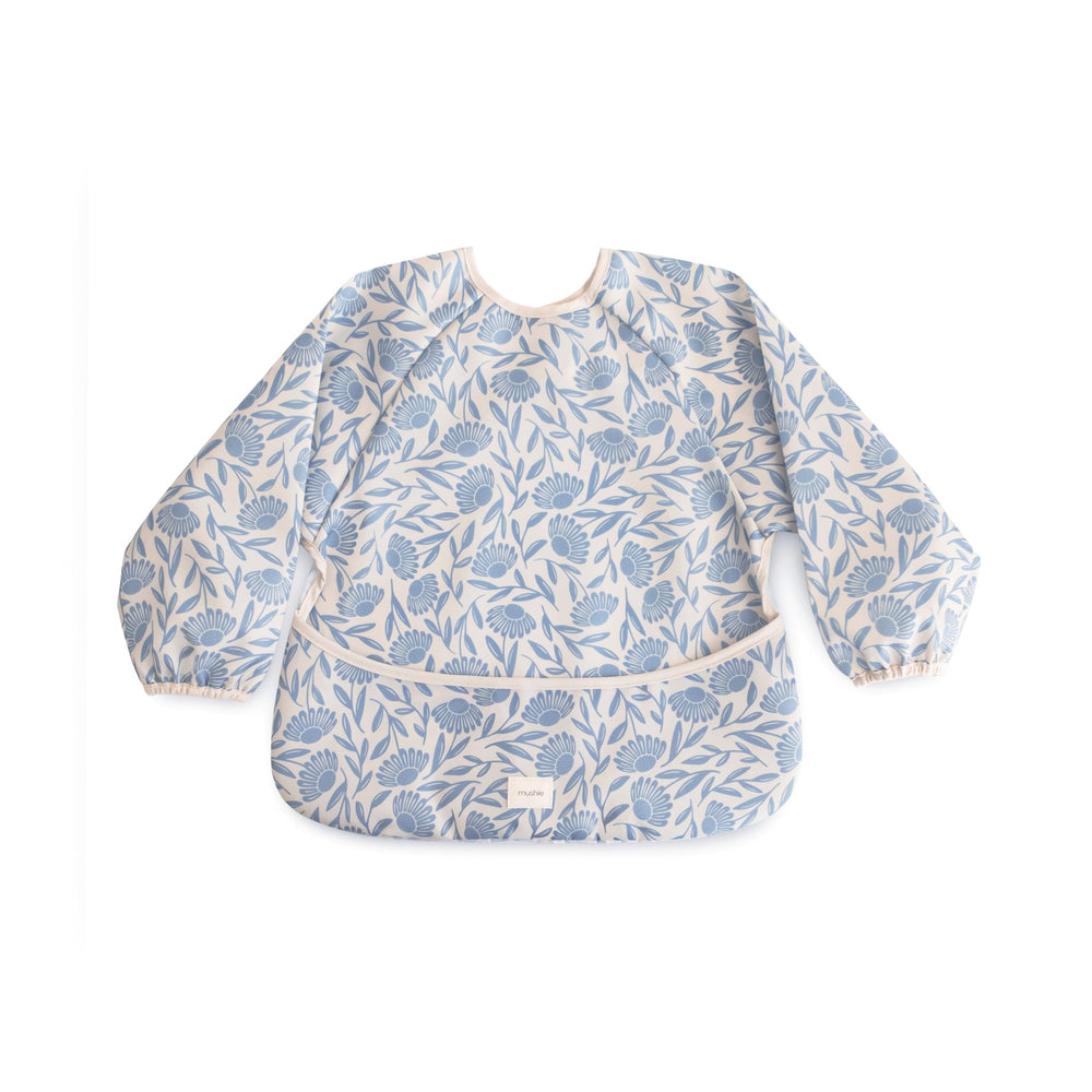 Mushie long sleeve bib blue flowers front view showing protective coverage during meals