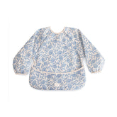 Mushie long sleeve bib blue flowers front view showing protective coverage during meals