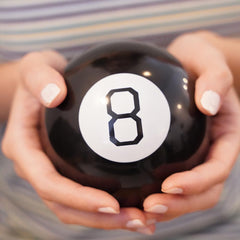 Mystic 8 Ball with friends in a circle for lighthearted group decision games
