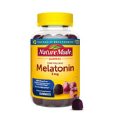 Nature Made Time Release Melatonin bottle on a nightstand for gradual sleep support