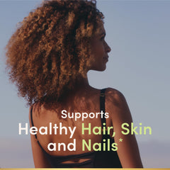 Nature's Bounty Biotin bottle with label showing 10,000 mcg per softgel for daily use.