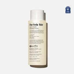 Foamy lather demonstrates gentle daily cleansing for all hair types with Nécessaire Shampoo.