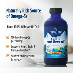 Pouring Arctic Cod Liver Oil into a glass for easy daily use.