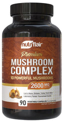 NutriFlair mushroom supplement bottle on desk for daily vitality.