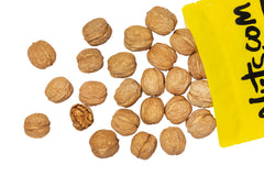 Nuts.com whole walnuts in shell on cutting board ready for cooking