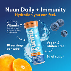 Nuun Immunity tablets dissolving in water for a fizzy blueberry-tangerine drink.