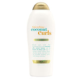 OGX Quenching + Coconut Curls Shampoo bottle on white surface, detangling focus