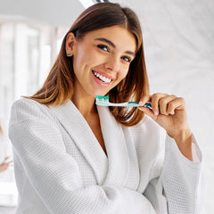 Closeup of brushing with Opalescence toothpaste for sensitive teeth