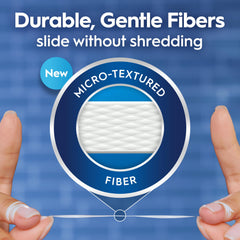 Close-up of smooth PTFE floss demonstrates easy sliding between teeth.
