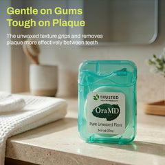OraMD floss close-up shows smooth texture for comfortable daily flossing.