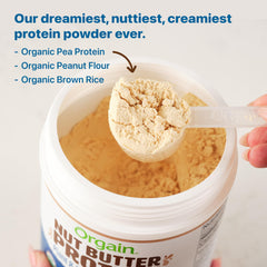 Orgain Vanilla Almond Butter protein powder being shaken into a glass for a creamy shake