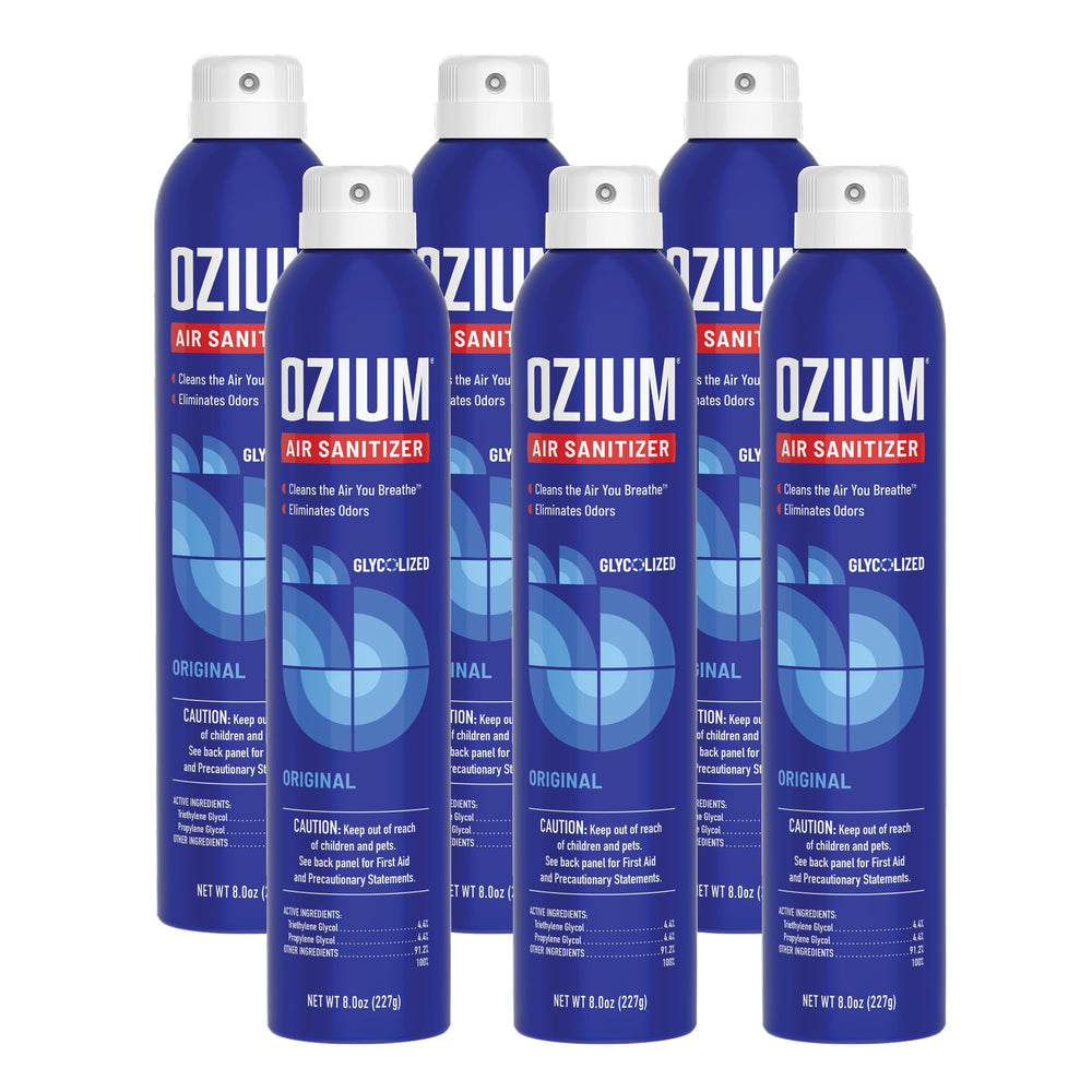 Ozium 8 oz bottle sprays to deodorize a car interior.