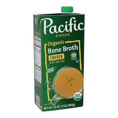 Pacific Foods organic chicken bone broth with sea salt carton on kitchen counter for quick, savory meals.
