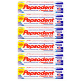 Pepsodent Complete Care toothpaste tube beside a toothbrush, supporting whitening through daily brushing.