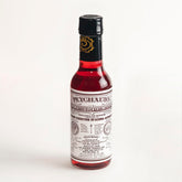 PEYCHAUD'S bottle-front label signaling heritage for authentic cocktails