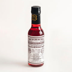 PEYCHAUD'S bottle-front label signaling heritage for authentic cocktails