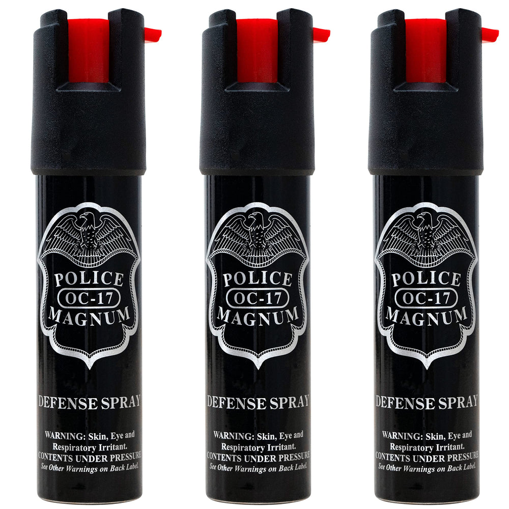 Police Magnum compact pepper spray canister in hand for personal safety.