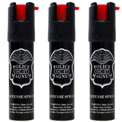 Police Magnum compact pepper spray canister in hand for personal safety.