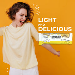 Power Crunch Lemon Meringue bar bite shot, showcasing a light, crunchy moment.