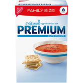 Premium Original Saltine Crackers packaging on a shelf for family-sized snacks.