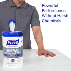 Wipe being used on a desk to sanitize a workspace with Purell