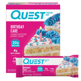 Quest Birthday Cake protein bar, unwrapped, rich flavor for post-workout fuel.