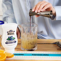Blueberry infusion with Pacific Northwest berries in a fresh ingredient shot.