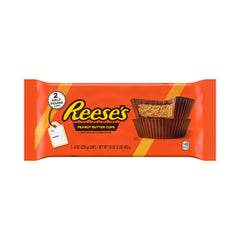 REESE'S Milk Chocolate Peanut Butter Cup Bar unwrapped, showing smooth chocolate and creamy filling