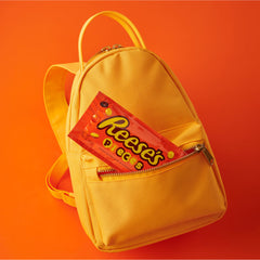 REESE'S PIECES movie-night setup beside a dessert plate