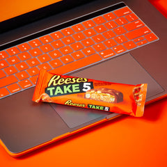 REESE'S Take 5 bars arranged on desk ideal for quick office treats.