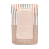 Roame Cloud 999 sanitizer spray bottle in hand for quick hygiene on the go.