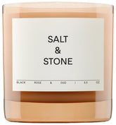 Salt & Stone Black Rose & Oud candle jar enhancing home fragrance and decor.