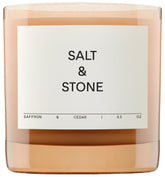 Salt & Stone saffron cedar candle jar creates a warm, inviting ambience.