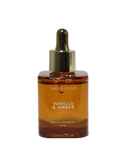 Sand + Fog Vanilla & Amber bottle pour shown for intimate, long-lasting fragrance.