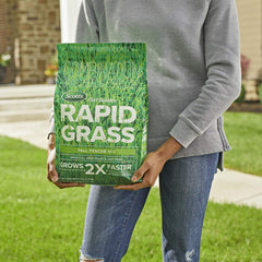 Scotts Turf Builder Rapid Grass seeds being spread across a prepared lawn.
