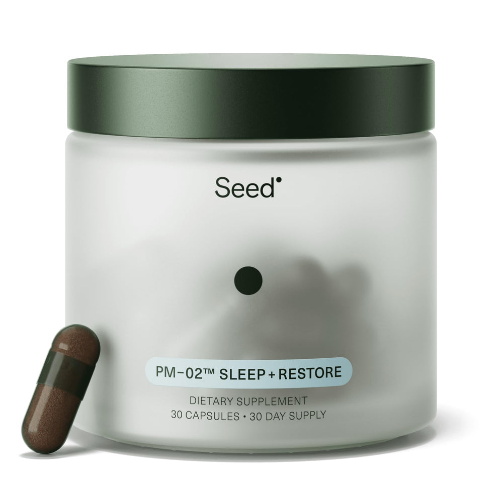 Seed PM-02 Sleep + Restore bottle on nightstand signaling restful nights.