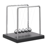 SEVNPRIME 5-bead Newton's cradle on a black base demonstrates momentum transfer on a desk.